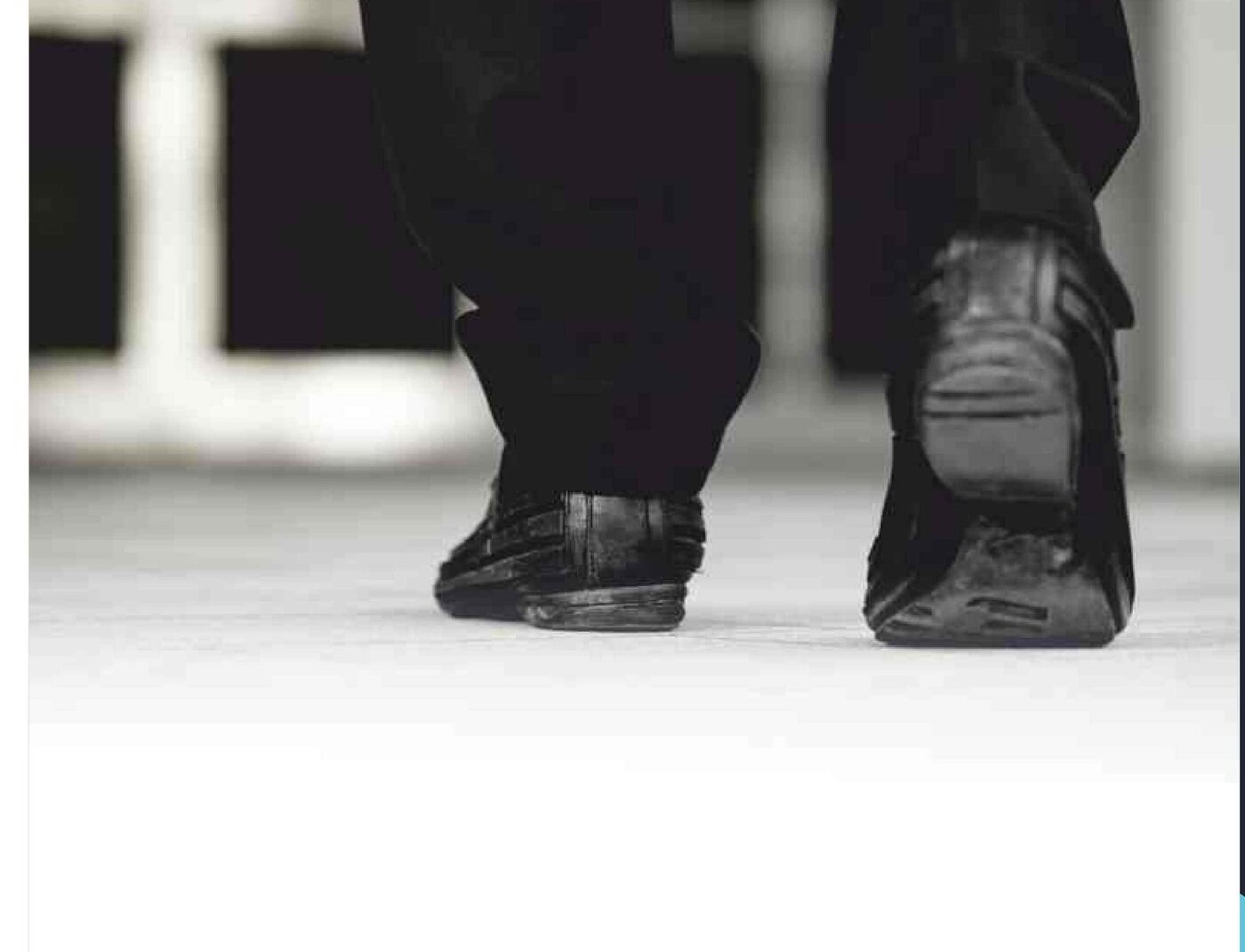 Visitors walking across an entrance mat